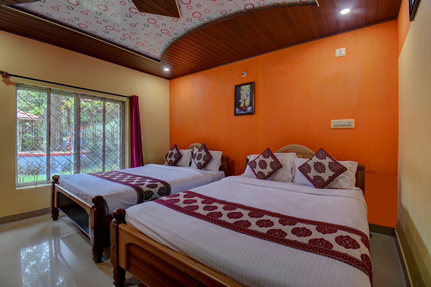 Elegant deluxe double bed suite featuring stylish orange highlight wall